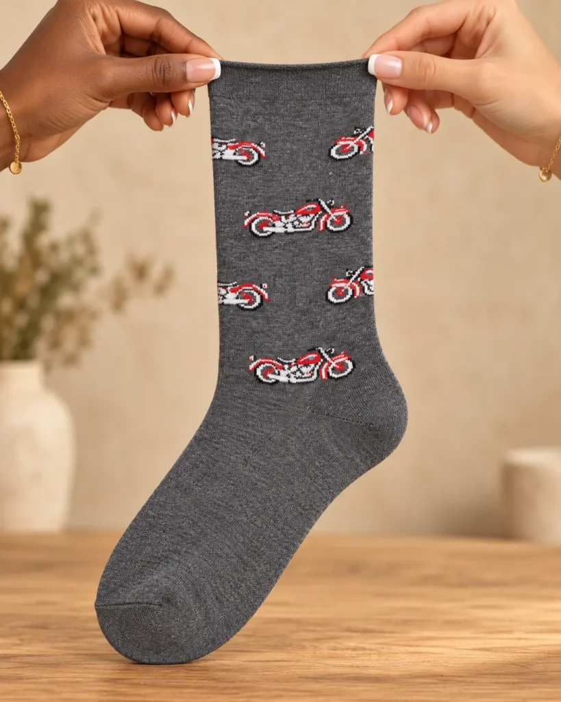 Grey socks with red motorcycles — held in hands
