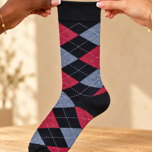 Black socks with blue and burgundy diamonds — held in hands