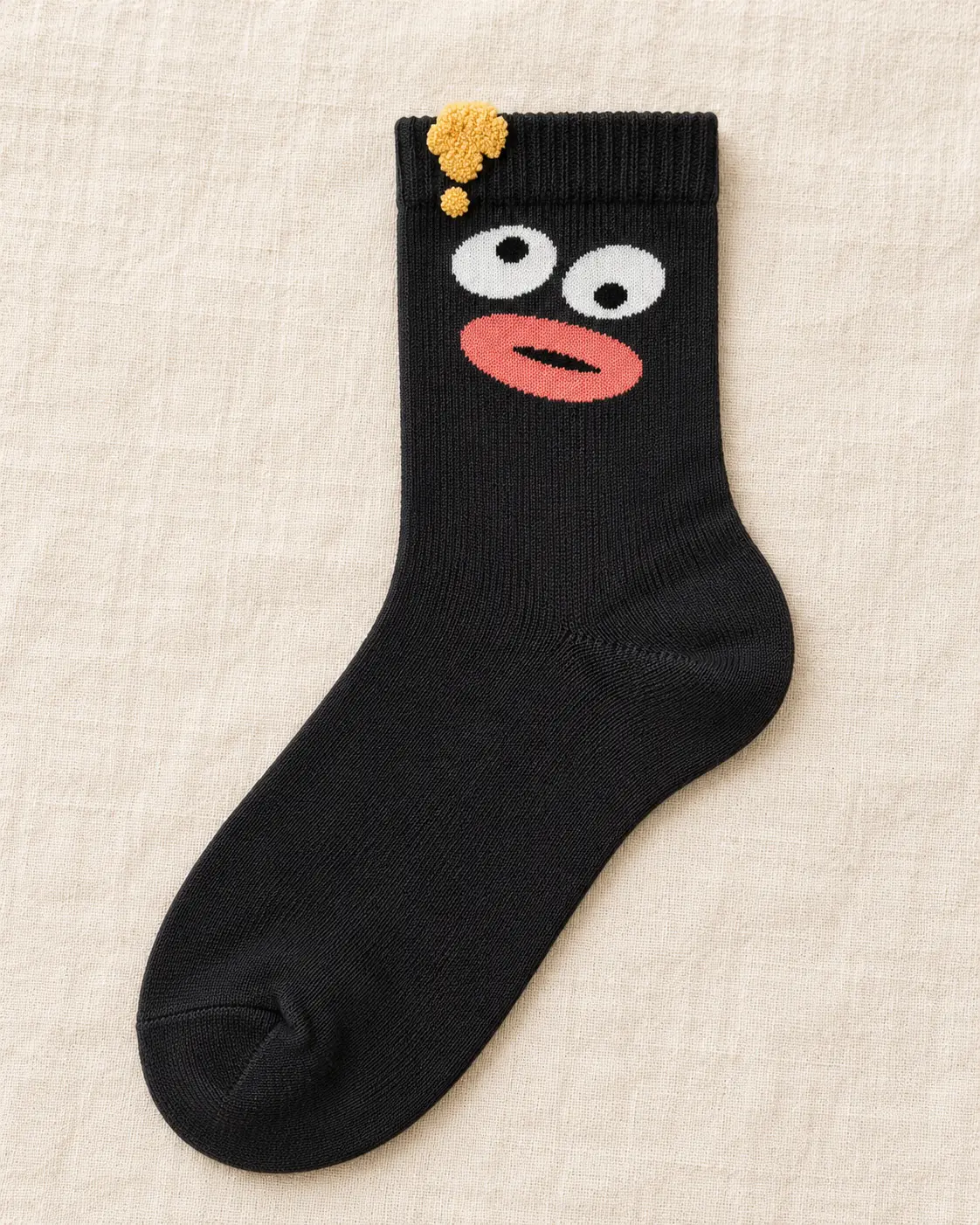 Black face socks with raised yellow detail — product view